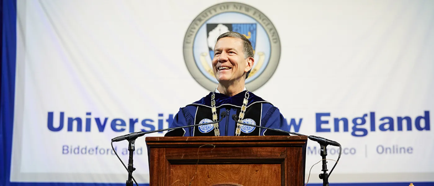 UNE President James Herbert speaks at the podium