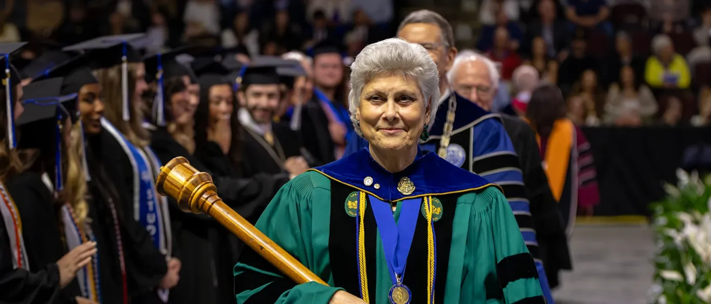 U N E faculty member Marilyn R. Gugliucci, Ph.D., Geriatrics Education and Research, leads the procession into commencement
