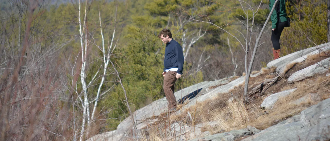 U N E students scale a cliff