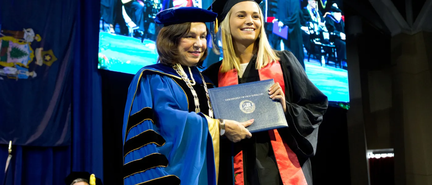 President Ripich poses with student at Commencement 2017