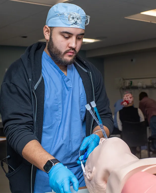 A nursing anesthesia student practices intubating a patient simulator
