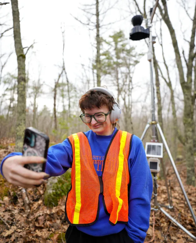 A student takes a selfie in front of the fully assembled weather station