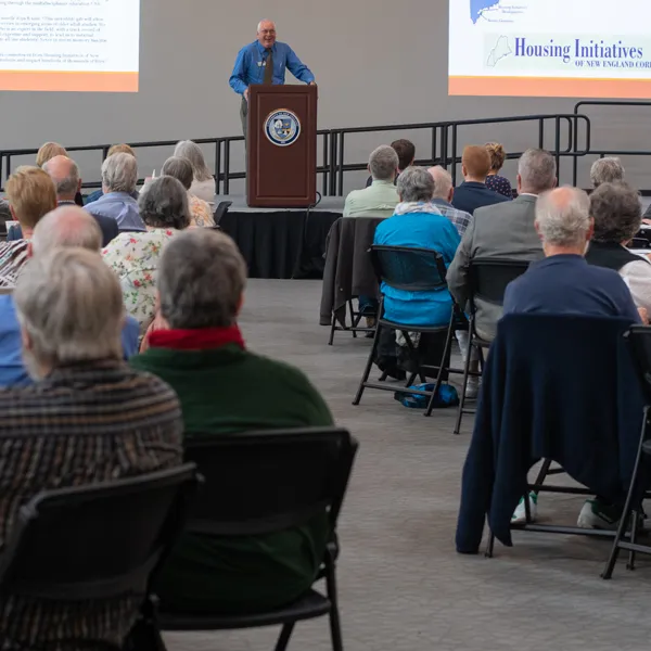 Tom Meuser speaks to an audience at a Legacy Scholars Breakfast for the Center of Excellence in Aging and Health