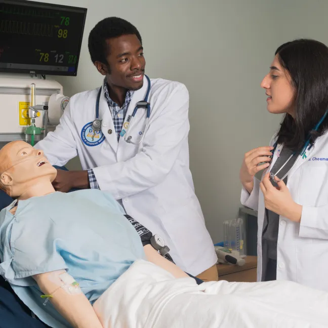 Two osteopathic medicine students in the simulation lab