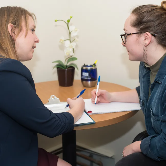 A student speaking with a staff member