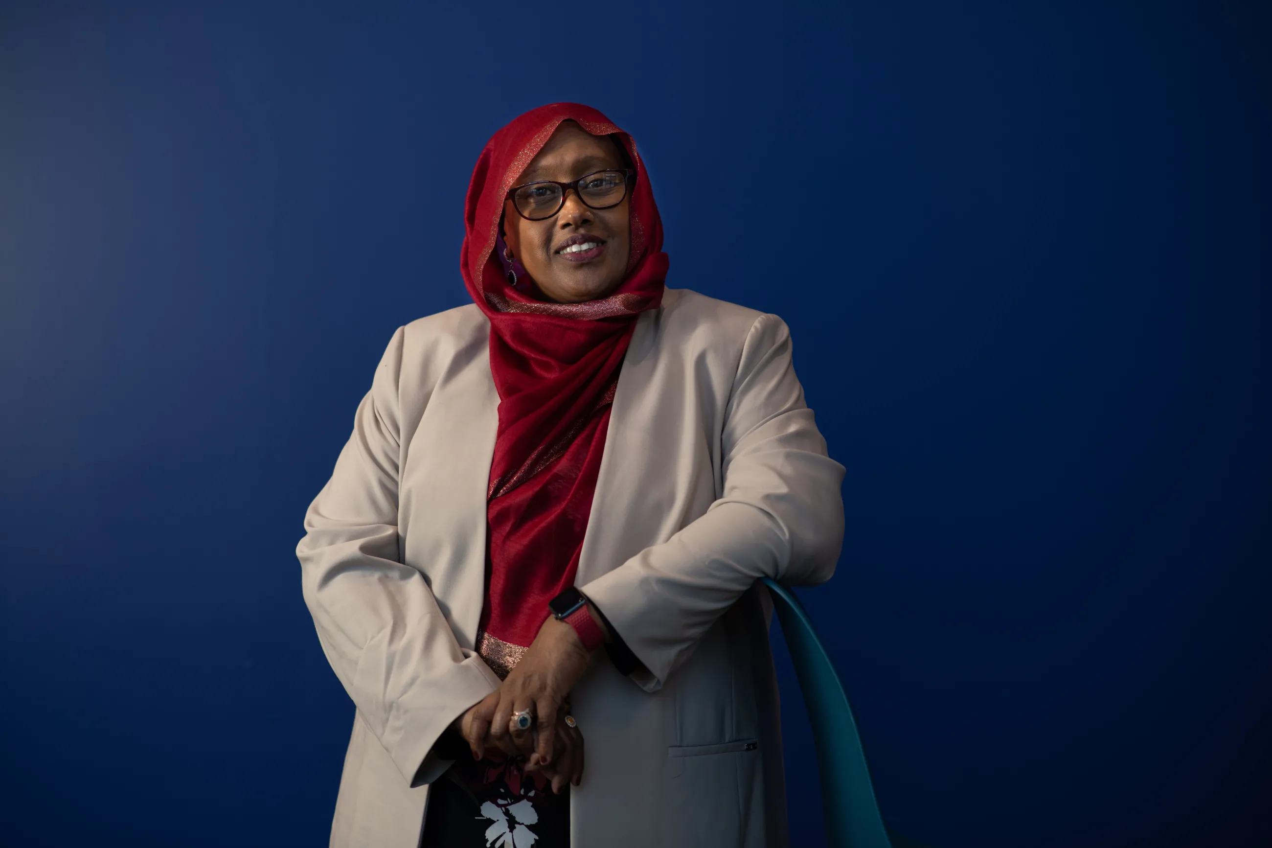 Deqa Dhalac stands and smiles for a photo