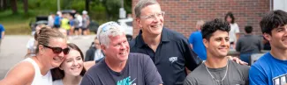 UNE President James Herbert poses with new and returning students