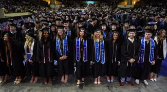 UNE graduates pose at the Cross Insurance Arena in Portland