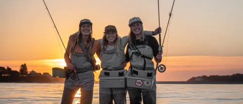 From left: UNE COM Class of 2023 students Hannah Akre, Kelsey Klingel, and Charlie Bloom — or, as they are known online, the Fishin’ Physicians.