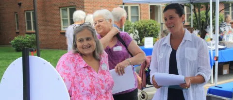 Two women stand at festival booth