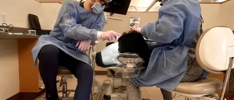 Dental students perform cleanings for children at the Oral Health Center's dental clinic
