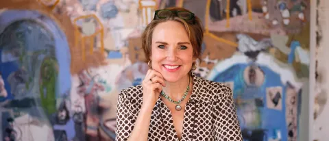 Erin McGee Ferrell in front of multimedia art supplies