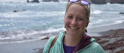 UNE's Sarah Ebel smiles in front of the Pacific Ocean
