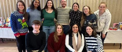A group of students poses for a photo in UNE's Campus Center