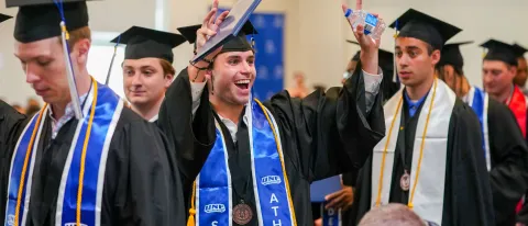 Students celebrate earning their diplomas at UNE's 2026 Commencement