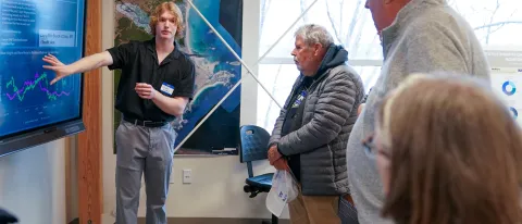 A UNE student delivers a presentation on weather data in UNE's Makerspace