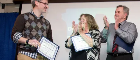 Craig Tennenhouse (left) receives the Excellence in Academic Advising Award for the College of Arts and Sciences, as Christine F