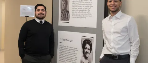 John Contreras and Brandon Barnett in front of the Black History Month display in Innovation Hall