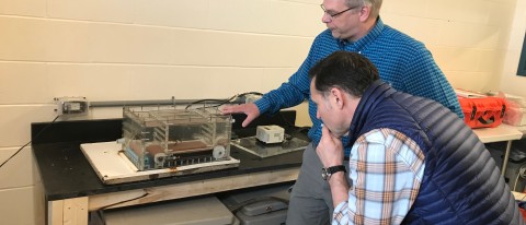 Markus Fredrich shows WCVB's Ted Reinstein how his treadmill for crabs works