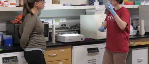 Eva Rose Balog and student researcher Laura Marvin in the lab