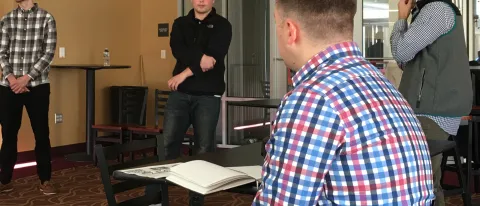 Students in the Sport Marketing course present their promotion plan for a Maine Mariners "College Fight Night" to Adam Goldberg