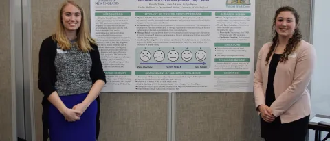 Assistant Clinical Professor Collyn Baeder (left) and Kassidy Towne '18 present at the 2018 HWOS Day of Scholarship.