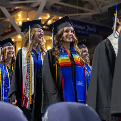 UNE students walk into the 2024 Commencement ceremony