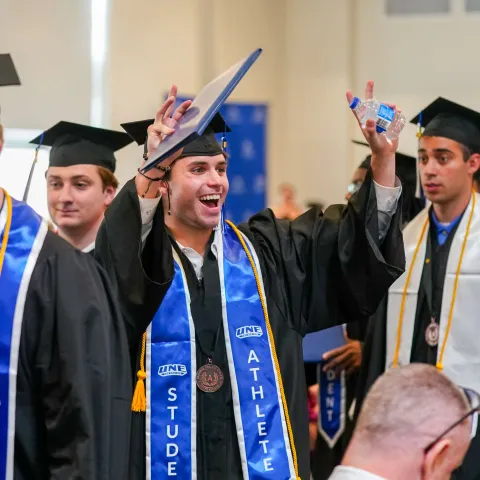 Students celebrate earning their diplomas at UNE's 2026 Commencement